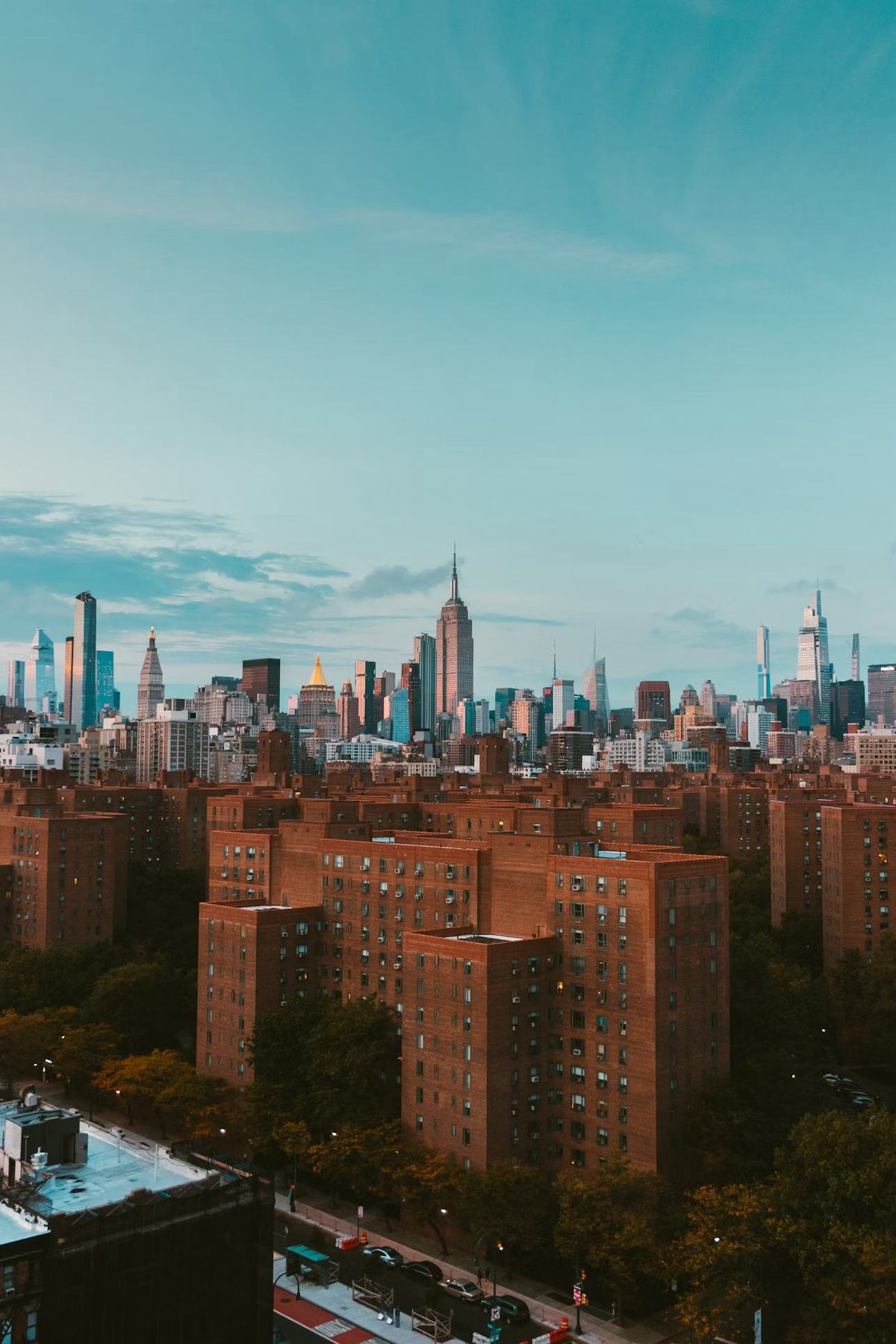 New York City skyline over brick rooftops
